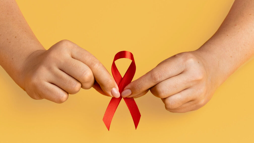 person holding a ribbon symbolizing HIV AIDS