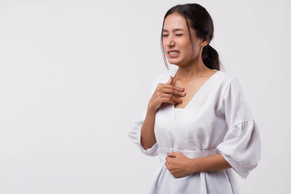 woman showing signs of gastroesophageal reflux disease
